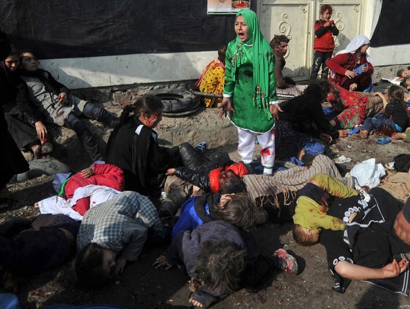 Tarana Akbari, 12, screams in fear moments after a suicide bomber detonated a bomb in a crowd at the Abul Fazel Shrine in Kabul on December 06, 2011. 